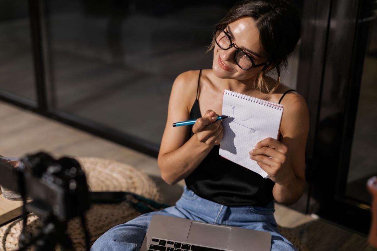 Natalie Tran on camera with a notebook