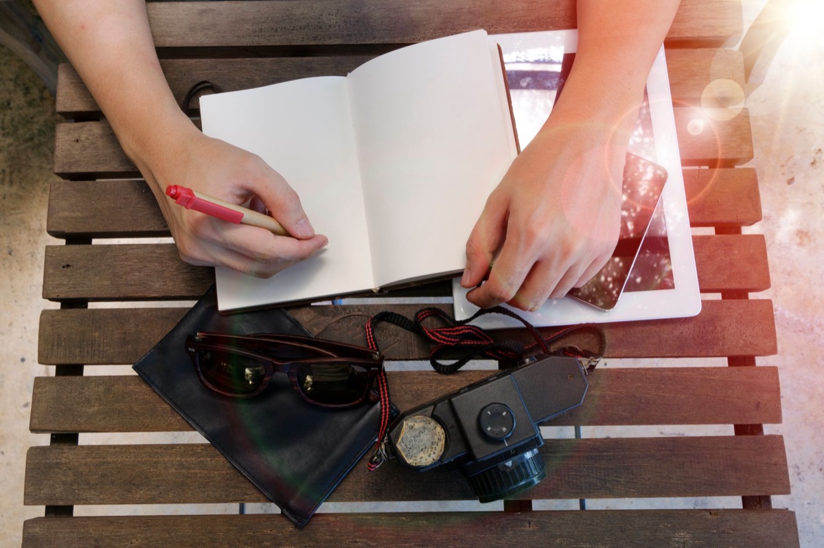 australian you-tuber with notebook and camera
